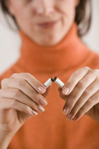 Woman breaking cigarette