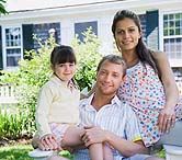 family in front of home