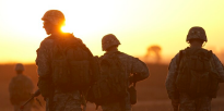 Army ROTC cadets walking across field