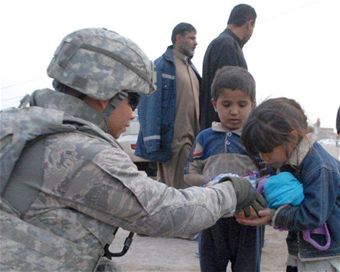 Service members give gifts to children