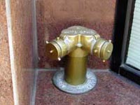 (Fig. 5.6) This FDC is mounted to close to a wall.  Other obstructions could be fences, pipes, downspouts, vegetation, etc.