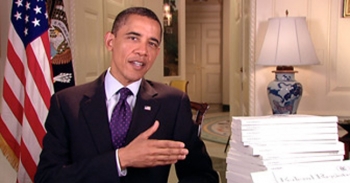 President Obama stands besie stack of the Federal Register