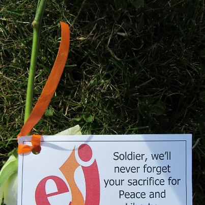 Photo: After the gravesite adoption ceremony at Henri-Chapelle American Cemetery in Belgium, many local citizens left flowers and messages at headstones. As a tradition that has occurred since the end of World War II, adopting a gravesite is an honored practice where local citizens pledge to help remember those buried and memorialized at our sites.