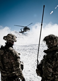 U.S. Army staff sergeants Neil Nunez and Justin Puchalsky, from Company A, 2nd Battalion 28th Infantry Regiment, Task force 3-66, watch the arrival of a helicopter in Afghanistan U.S. Army Photo By Staff Sgt. Charles Crail, Task Force Blackhawk Public Affairs