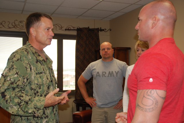 Navy Adm. James A. Winnefeld Jr., vice chairman of the Joint Chiefs of Staff, visits with Spc. Joel Sigfrid and his family at the San Antonio Military Medical Center in San Antonio, Oct. 12, 2012. Sigfrid was injured Oct. 3, 2012, while supporting Operation Enduring Freedom. During his visit, Winnefeld met with wounded warriors in the hospital and Center for the Intrepid, a state-of-the-art rehabilitation center, and also presented two Purple Hearts to Soldiers during an early morning ceremony.