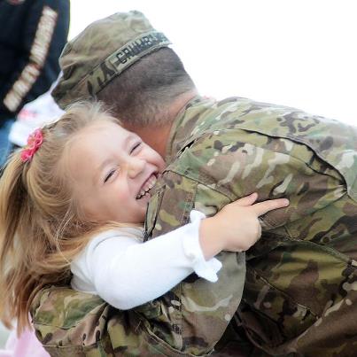 Photo: A Soldier from the Michigan National Guard is welcomed home by his daughter after a year long tour in Afghanistan on Sept. 28. Photo by Staff Sgt. Helen Miller.