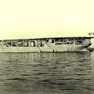 Photo: USS Langley (CV-1).  At anchor, with an Aeromarine 39-B airplane landing on her flight deck, circa 1922.  NHHC Photograph Collection:  NH 63545.