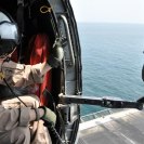 Photo: 120930-N-YX169-017 ARABIAN SEA (Sep. 30, 2012) –Hospital Corpsman 2nd Class Jacob A. Jeffreys of the Nightdippers of Helicopter Anti-submarine Squadron (HS) 5 watches the flight deck of the Nimitz-class aircraft carrier USS Dwight D. Eisenhower (CVN 69) drop away as the SH-60F helicopter he’s in takes off.  Eisenhower is deployed to the U.S. 5th Fleet area of responsibility conducting maritime security operations, theater security cooperation efforts and support mission as part of Operation Enduring Freedom.  (U.S. Navy photo by Mass Communication Specialist 1st Class Nathanael Miller/Released)