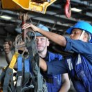 Photo: 121011-N-YX169-047 ARABIAN SEA (Oct. 11, 2012) – Seaman Marcus McDowell and Boatswain’s Mate Seaman (SW) Gunnar Luna unhook a cargo net aboard Nimitz-class aircraft carrier USS Dwight D. Eisenhower (CVN 69) after receiving stores from fleet replenishment oiler USNS Laramie (T-AO 203) during a replenishment-at-sea. Eisenhower is deployed to the U.S. 5th Fleet area of responsibility conducting maritime security operations, theater security cooperation efforts and support mission as part of Operation Enduring Freedom. (U.S. Navy photo by Mass Communication Specialist 1st Class Nathanael Miller/Released) MC1(AW/SW) Nathanael Miller