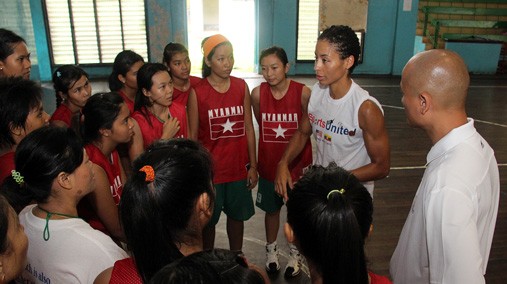 Allison Feaster and Rich Cho speak with female basketball athletes in Rangoon, Burma, August 2012. [State Department photo/ Public Domain]