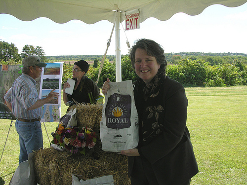 Deputy Agriculture Secretary Kathleen Merrigan holds a sack of Rhode Island potatoes produced at Ferolbink Farm