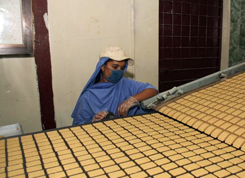 A Bangladeshi factory worker monitors the production of biscuits made from U.S. donated wheat. The donation was delivered to the World Food Programme, a Foreign Agricultural Service (FAS) McGovern-Dole program participant that works to provide food assistance in more than 73 countries. The biscuits will be distributed to about 2,000 schools in the poorest areas of Bangladesh.  (Photo courtesy U.S. Embassy New Dehli)