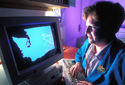 Soil microbes can be used to trace dust to its source. Soil microbiologist Ann Kennedy checks a computer map that shows the location of various biological groupings across the Columbia Plateau in Washington State.