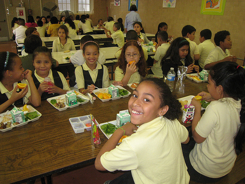 Schoolchildren at Bruce-Monroe Elementary School in Washington, D.C. celebrate lunch after receiving their Gold Award of Distinction honor through USDA’s HealthierUS School Challenge.