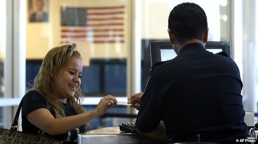 Woman shows her U.S. passport card to inspecting officer in El Paso, Texas, June 1, 2009. [AP File]