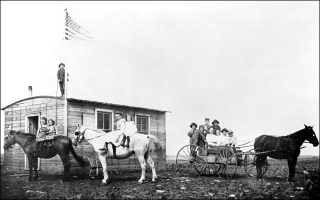 Students outside a one room school house