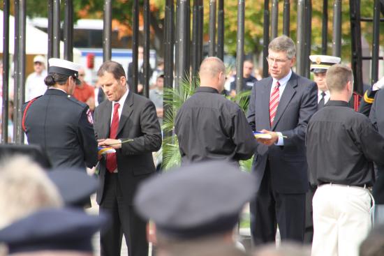 Presenting a flag to the families of fallen firefighters