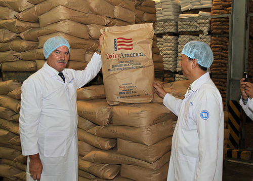 Acting Under Secretary for Farm and Foreign Agricultural Services Michael Scuse (left) tours a Vinamilk factory in Ho Chi Minh City, Vietnam and sees dairy products the company has imported from the United States. Vinamilk is Vietnam’s largest dairy processing company and its general manager, Nguyen Quoc Khanh (right) is a 1998 alum of the Foreign Agricultural Service’s Cochran Fellowship Program. Scuse was in Vietnam last week leading USDA’s first agricultural trade mission there. Photo by Le Sy Hoang Chuong 