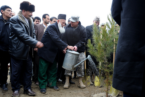 General David Petraeus, ISAF Commander, and Haji Habibi, Director General for the Greenery Department, water a newly planted tree during a ceremony in honor of Nowruz at the Bi Bi Mahro Park on Wazir Akbar Khan Hill in Kabul, Afghanistan on Sunday, March 6, 2011. (S.K. Vemmer/Department of State)