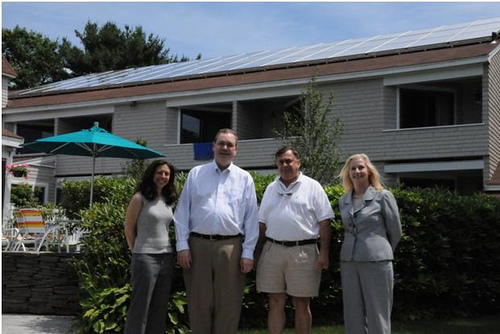 Standing in front of the solar panels on the hotels roof are (Left to Right)  Allyson Cavaretta, Under Secretary Dallas Tonsager, Owner Phillip Cavaretta, and Maine State Director Virginia Manuel. The energy saving panels were funding in part with funds from USDA’s Rural Energy for America Program.