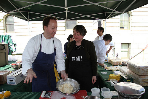 USDA Deputy Secretary assists Chef Eric Ziebold with a cooking demonstration at the kick-off of the USDA Summer Farmers Market.