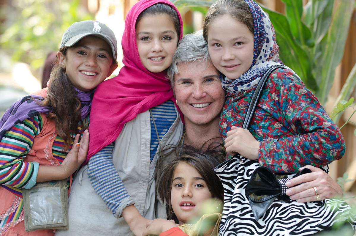 Children at the HQ ISAF, Kabul Women’s Bazaar with Laura Walko, civilian employee. (U.S. Army photo by Sgt. Christopher Harper)