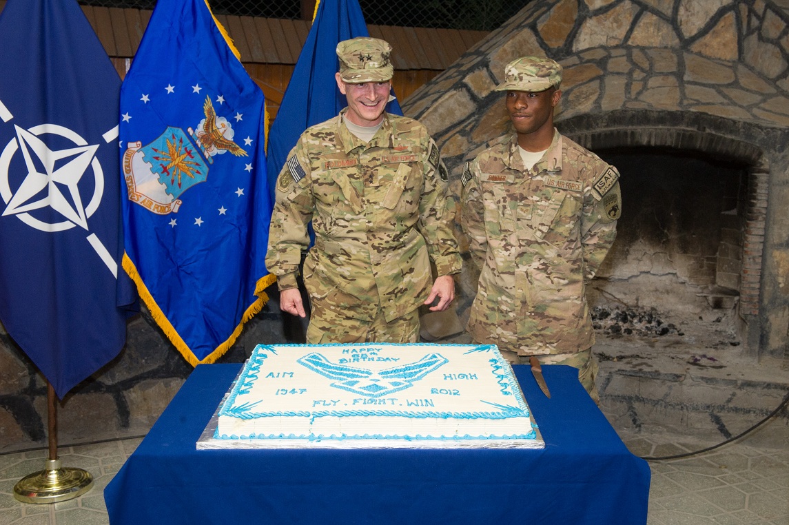 Maj. Gen. H D Polumbo Jr. and SrA Daniel Conner prepare to cut the cake for the Air Force 65th birthday, HQ ISAF, Kabul. (U.S. Army photo by Sgt. Christopher Harper) 