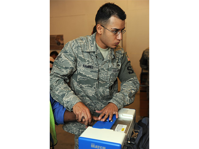 U.S. Air Force Senior Airman Juan Ramirez, with the 379th Expeditionary Security Forces Squadron, processes a third country national into the Defense Biometrics Identification System (DBIDS) at an undisclosed location in Southwest Asia Aug. 3, 2009. DBIDS is an enhanced security system used to monitor entry on military installations. Airman Ramirez is deployed here from Maxwell Air Force Base, Ala. (U.S. Air Force photo by Staff Sgt. Robert Barney/Released)