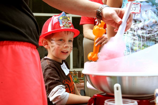 KayCee Chaney, 5, watches intently as Sgt. 1st Class Tanya Savell-Marzan makes cotton candy during the U.S. Army Space and Missile Defense Command/Army Forces Strategic Command-sponsored Survivor Outreach Services Fall Fest at the home of Lt. Gen. Richard P. Formica, SMDC commanding general, Oct. 13.