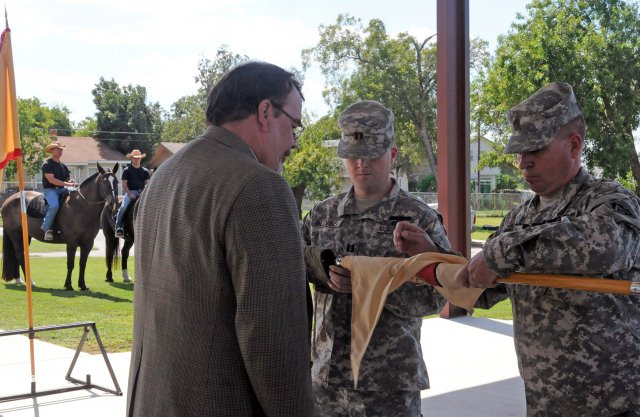 FORT SAM HOUSTON, Texas - Capt. James Blevins, company commander of Headquarters and Headquarters Company, Army Support Activity, and 1st Sgt. Anthony Walls, case the company guidon during an inactivation ceremony held Oct. 2 as Frank Blakely, ASA manager, looks on. The Military Honors Platoon, which provides military funeral honors in the south Texas region and ceremonial support to Fort Sam Houston and the greater San Antonio military community, is now part of Army North's Headquarters Support Company, Headquarters and Headquarters Battalion, U.S. Army North. 
(U.S. Army photo by Staff Sgt. Corey Baltos, Army North PAO)