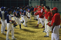 Members of the Marine all-star baseball team and the Social Original Local Academy baseball team shake hands prior to a friendly competition at Camp Foster Oct. 11. The people of Okinawa and Marines may have cultural differences, but they all disappear on the baseball field, according to Hiroshi Yurino, the captain of the Okinawan team. 