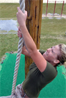 Lance Cpl. Jessica M. Hall climbs a rope at the obstacle course and simulated casualty evacuation station during small-unit leadership training at Marine Corps Air Station Futenma Oct. 12. Marines moved through a traditional obstacle course before rigging a field-expedient litter and evacuating a Marine to a casualty collection point. Hall is a motor vehicle operator with Marine Air Support Squadron 2, Marine Air Control Group 18, 1st Marine Aircraft Wing, III Marine Expeditionary Force. 