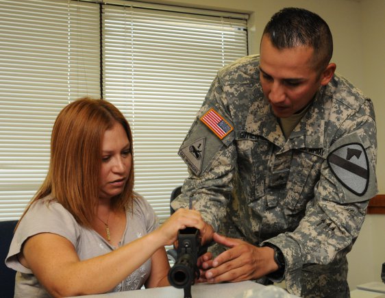 FORT HOOD, Texas-- Sgt. Efrain Gutierrez, an engineer with Company C., 2nd Brigade Special Troops Battalion, 2nd "Black Jack" Brigade Combat Team, 1st Cavalry Division, assists Denise Snyder, logistics assistance representative with the U.S. Army Tank-Automotive and Armament Command, on properly disassembling a M26 Modular Accessory Shotgun System during a new equipment training class here, Oct. 2.