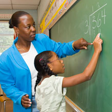 Teacher helping student with math problem