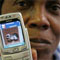 Woman holding a cell phone with an image dsiplayed on the screen. (AP Images)