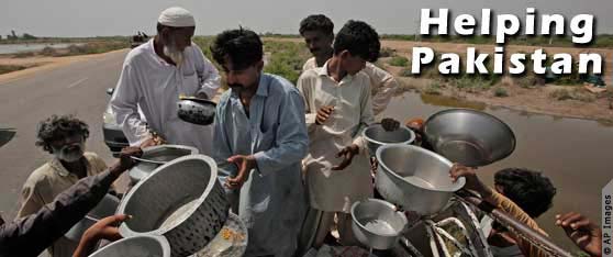 Pakistanis receiving emergency food in buckets (AP Images)