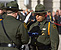 Members of the Customs and Border Protection Honor Guard carefully hand off and offer a salute to a ceremonial flag in Washington D.C. at a CBP memorial service.