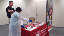 Dr. Karl Gustavson, Engineer Research and Development Center, looks on as a student conducts an experiment to show the effects of oil spill dispersants on surface oil and tools used by ERDC to assess the environmental effects of the oil.