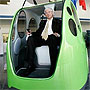 Man sitting in futuristic car (AP Images)