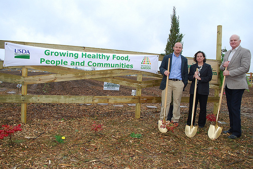 Matt Feno, left, NRCS district conservationist in Carthage, Texas, Livia Marqués, director of the USDA People’s Garden Initiative and Don Gohmert, NRCS state conservationist for Texas, took advantage of a break in the rain showers. 