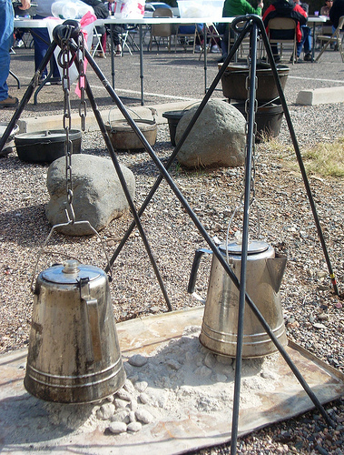 Coffee perks over a hot bed of coals. Generally, cowboy coffee is made by putting the grounds right in the water.