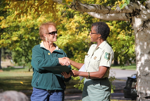 Gloria Owen being honored by Regional Forester Leslie Weldon at the Lolo National Forest’s new pollinator garden at Fort Missoula.  (Photo Credit: Joni Packard, US Forest Service)