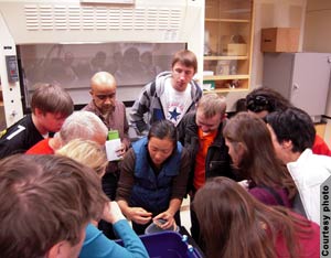 Group of people around assistant showing mussel (Courtesy of Tahoe-Baikal Institute)