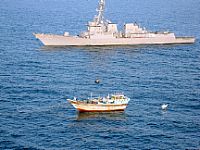 The guided-missile destroyer USS Kidd (DDG 100) responds to a distress call from the master of the Iranian-flagged fishing dhow Al Molai, who claimed he was being held captive by pirates.