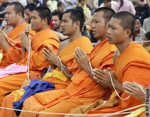 Monks in orange robes (AP Images)