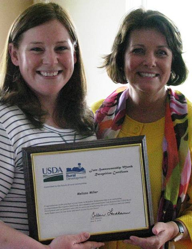 New homeowner Melissa Miller (Left) and Colleen Landkamer, State Director, USDA Rural Development, celebrate Miller’s accomplishment.  