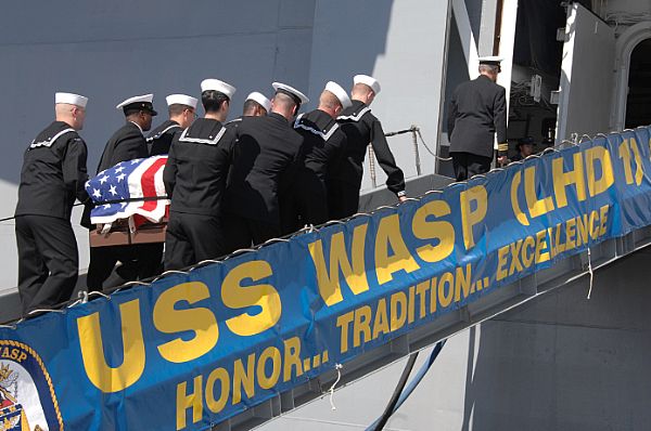 Sailors assigned to the pallbearer detail walk up the brow of the amphibious assault ship USS Wasp (LHD 1) while carrying the coffin of a former service member for an upcoming burial at sea. Wasp is currently preparing for a scheduled underway. The U.S. Navy has a 237-year heritage of defending freedom and projecting and protecting U.S. interests around the globe. Join the conversation on social media using #warfighting.  U.S. Navy photo by Mass Communication Specialist 2nd Class Gretchen Albrecht (Released)  121018-N-NR998-107