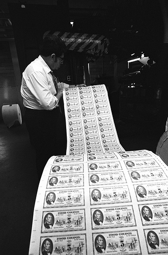 A Bureau of Printing and Engraving employee examines a run of food stamps for the U.S. Department of Agriculture for errors in May 1974. Photo courtesy National Archives and Records Administration.