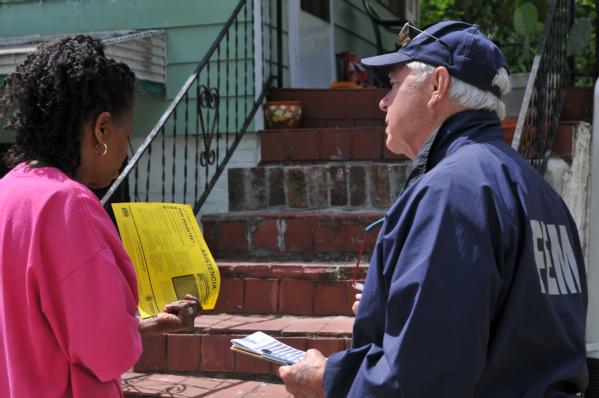 FEMA Community Relations Specialist Steve Huffstutler explains the registration process to a homeowner