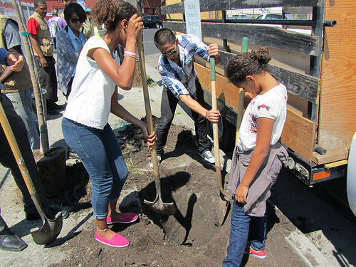 Local young people prepare the ground for tree plantings at the Urban Releaf ceremony in Oakland, Calif., on Aug. 20.